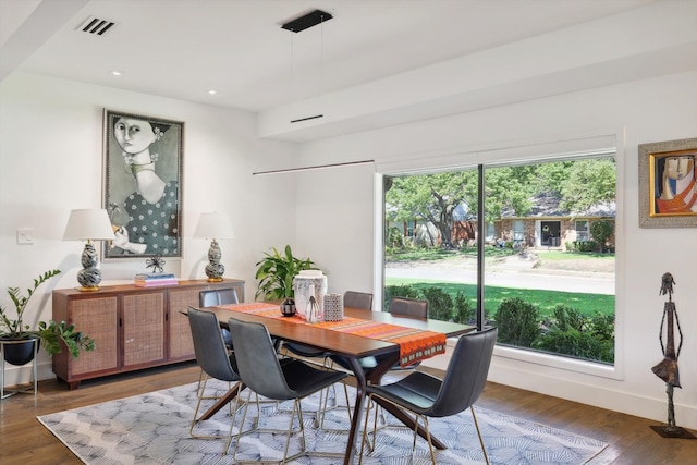 dining area with plenty of natural light and dark hardwood / wood-style flooring