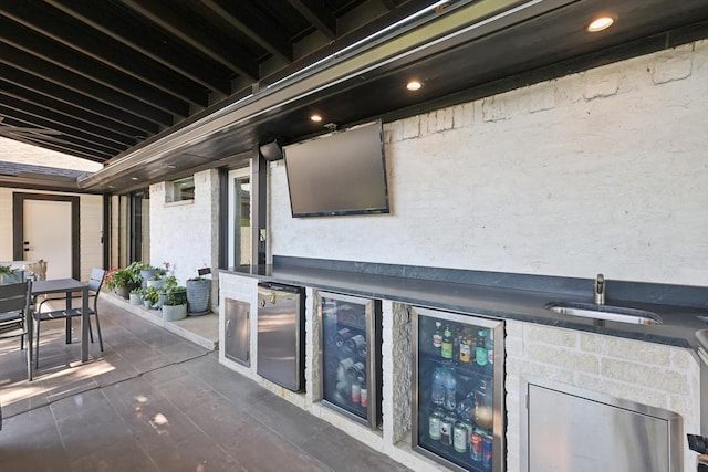 view of patio featuring wine cooler and sink