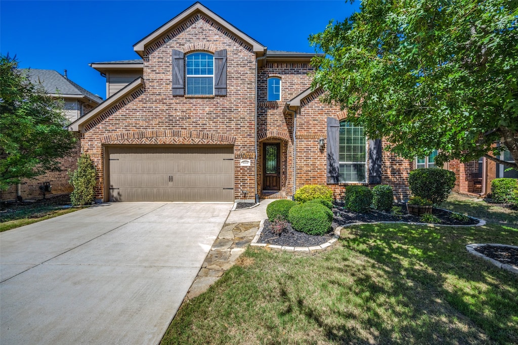 view of front property featuring a front yard and a garage