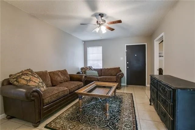 tiled living room with ceiling fan