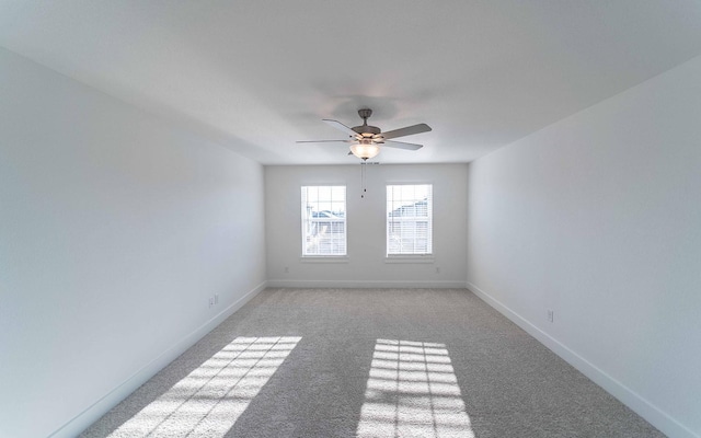 empty room featuring light colored carpet and ceiling fan