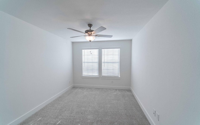 spare room featuring light colored carpet and ceiling fan