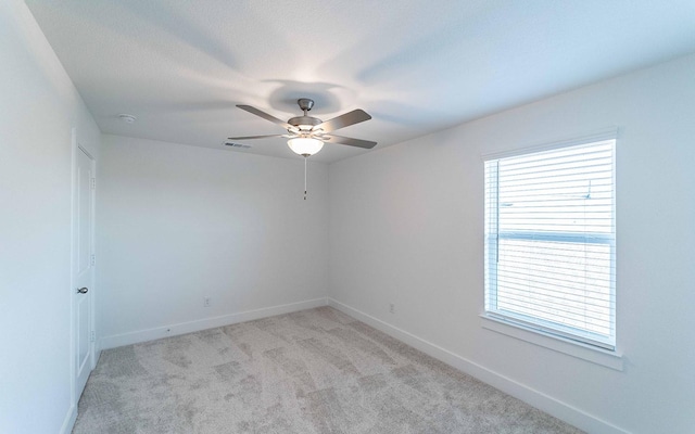 empty room with ceiling fan and light colored carpet