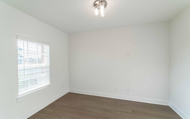 empty room with dark wood-type flooring