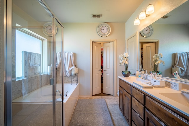 bathroom featuring vanity, shower with separate bathtub, tile patterned floors, and a healthy amount of sunlight