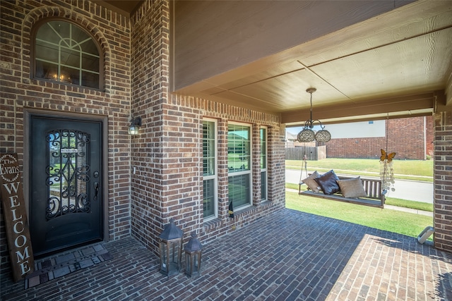 view of exterior entry with a patio area