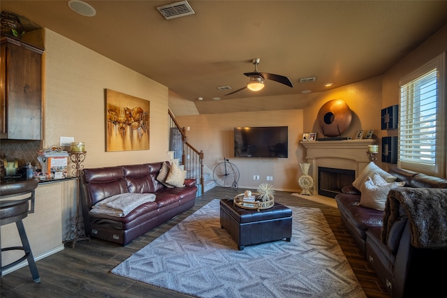 living room featuring dark hardwood / wood-style floors and ceiling fan