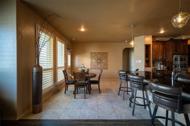 dining area with light tile patterned floors