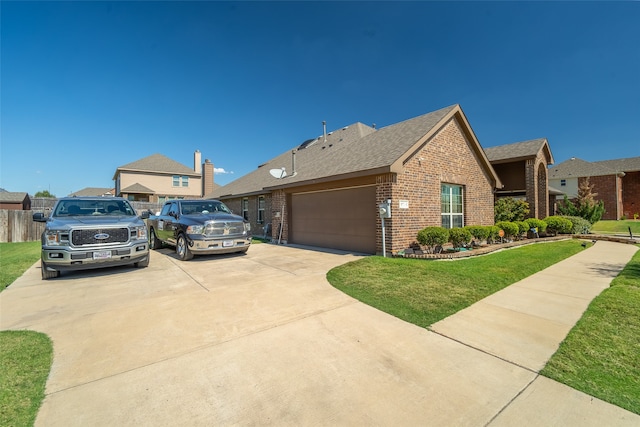 view of front of home with a garage and a front lawn