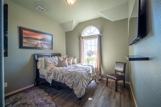 bedroom featuring vaulted ceiling and dark wood-type flooring