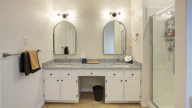 bathroom featuring vanity, an enclosed shower, and tile patterned floors