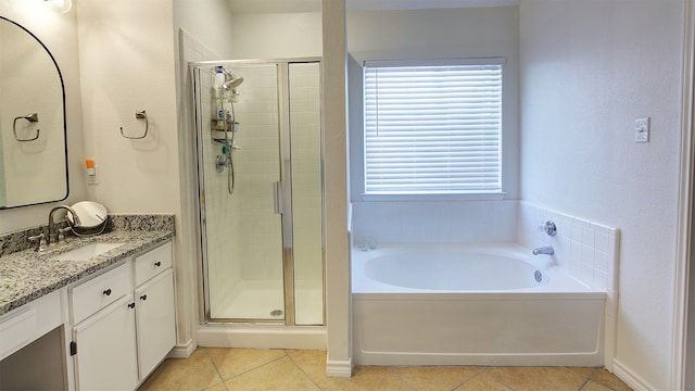 bathroom featuring vanity, plus walk in shower, and tile patterned flooring