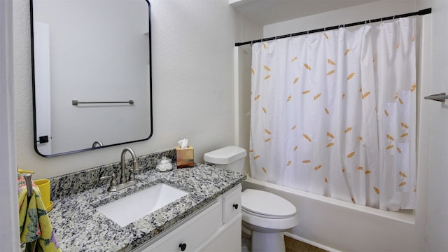 full bathroom with vanity, shower / bath combo with shower curtain, and toilet