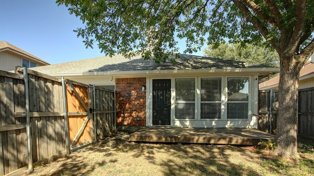 rear view of property with a wooden deck