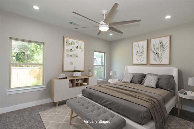 bedroom with carpet floors, multiple windows, and ceiling fan