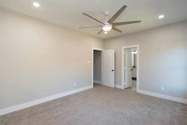 unfurnished bedroom with ceiling fan and light colored carpet