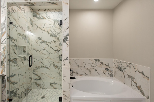 bathroom featuring separate shower and tub