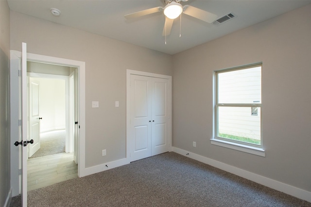 unfurnished bedroom with carpet floors, a closet, and ceiling fan