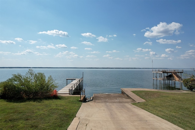 view of dock featuring a water view and a yard