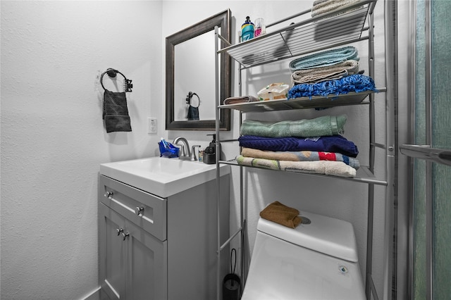 bathroom featuring vanity and toilet