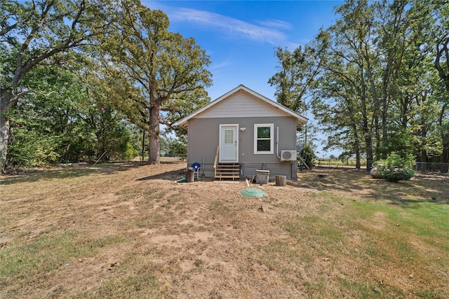 rear view of house featuring a yard