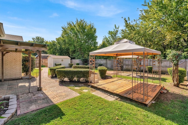 view of yard with a gazebo and a storage unit