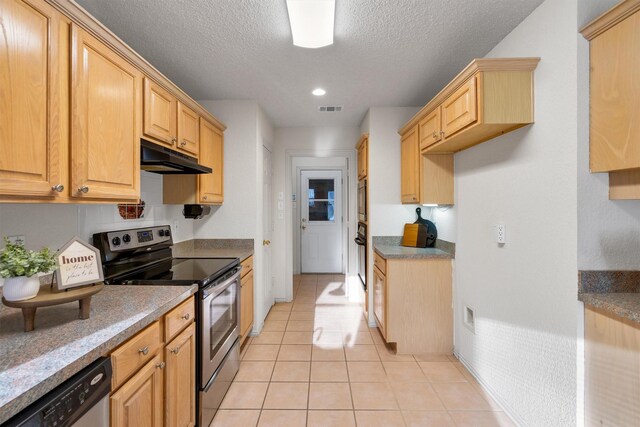 clothes washing area with cabinets, light tile patterned floors, hookup for a washing machine, hookup for an electric dryer, and a textured ceiling