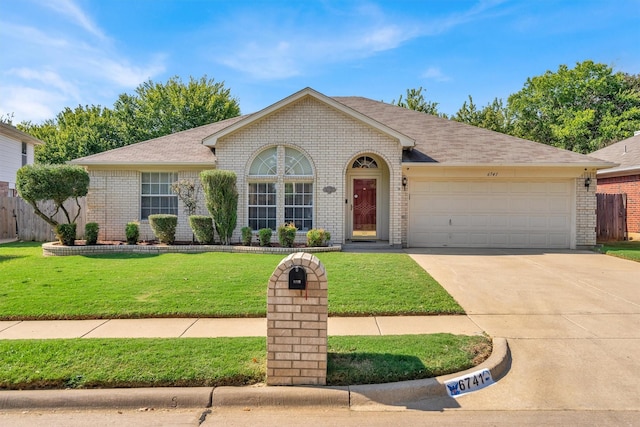 ranch-style house featuring a front lawn and a garage