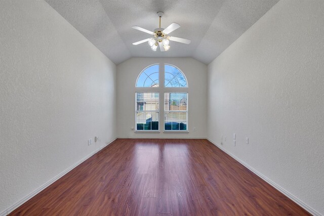 spare room featuring lofted ceiling, a textured ceiling, dark hardwood / wood-style flooring, and ceiling fan