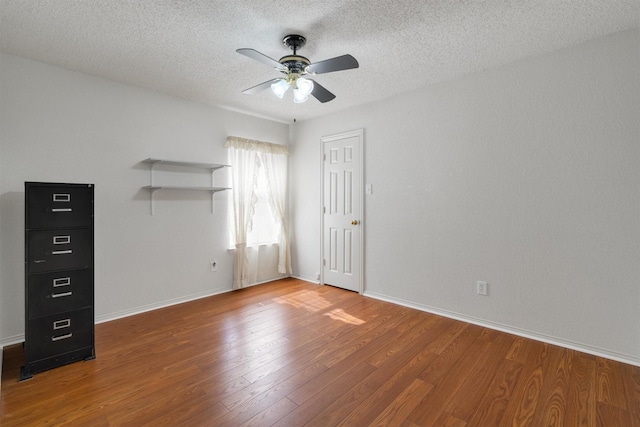 spare room featuring wood-type flooring, a textured ceiling, and ceiling fan