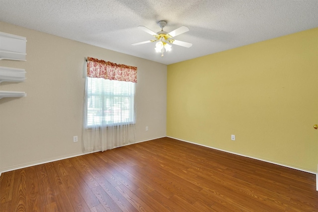 spare room featuring ceiling fan, hardwood / wood-style flooring, and a textured ceiling