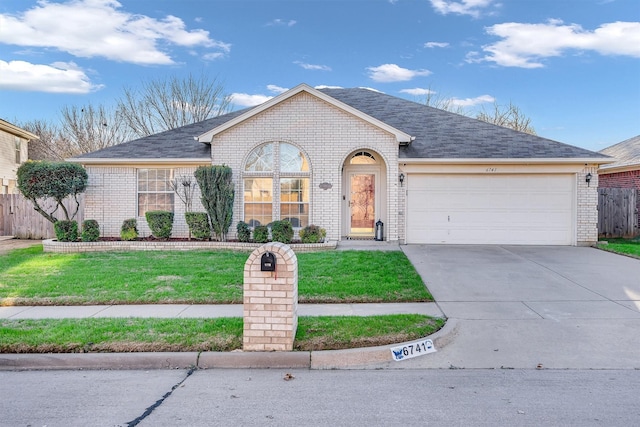 ranch-style home with a garage and a front lawn