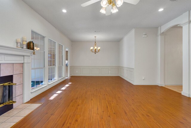 dining area featuring ceiling fan with notable chandelier and light hardwood / wood-style floors