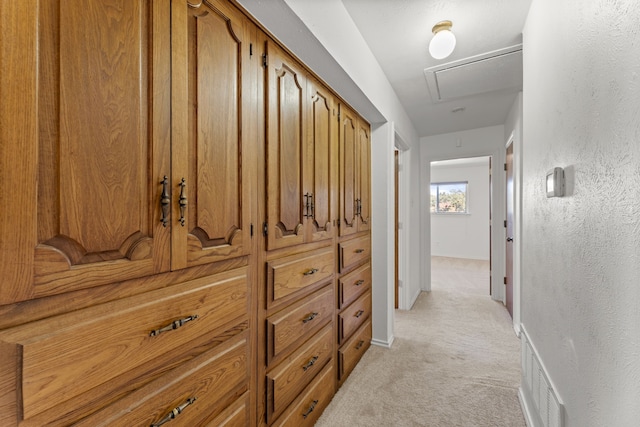 hall with light colored carpet