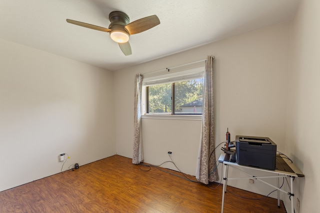 empty room featuring wood-type flooring and ceiling fan