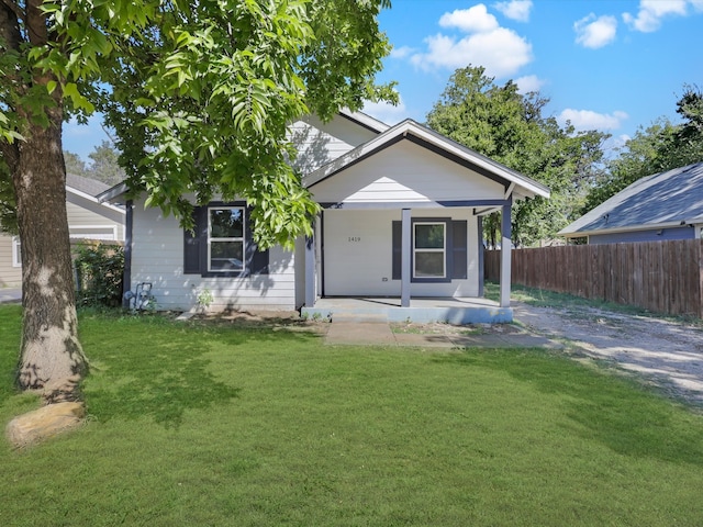 back of house with a lawn