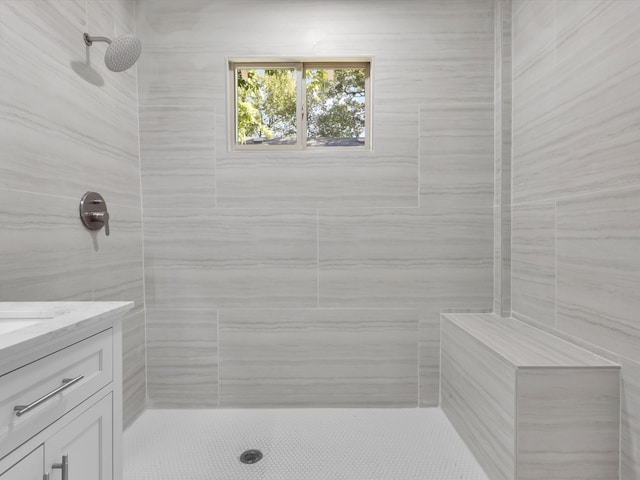 bathroom with vanity and tiled shower