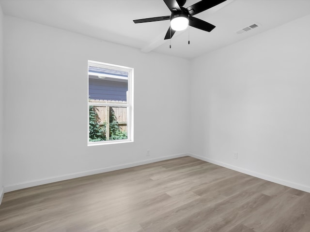 spare room featuring light wood-type flooring and ceiling fan