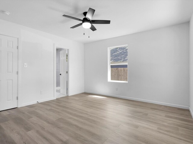 empty room with light hardwood / wood-style floors and ceiling fan