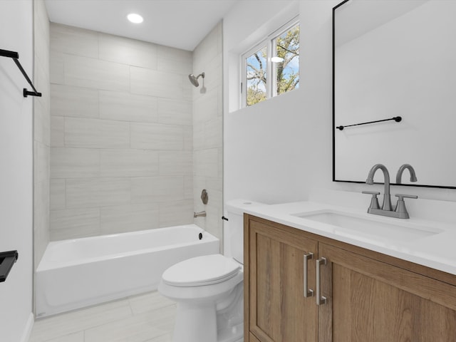 full bathroom with vanity, toilet, and tiled shower / bath