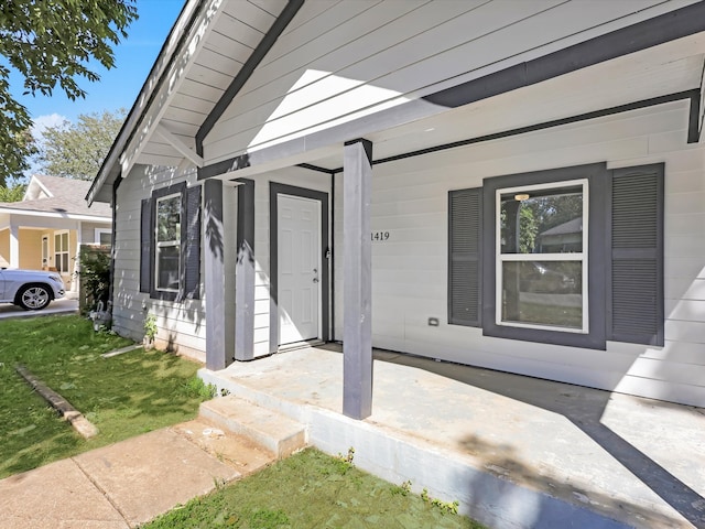 view of exterior entry with a porch