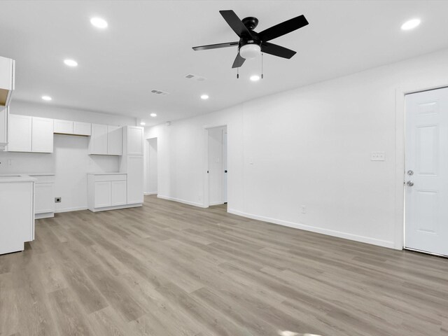 unfurnished living room featuring light hardwood / wood-style floors and ceiling fan