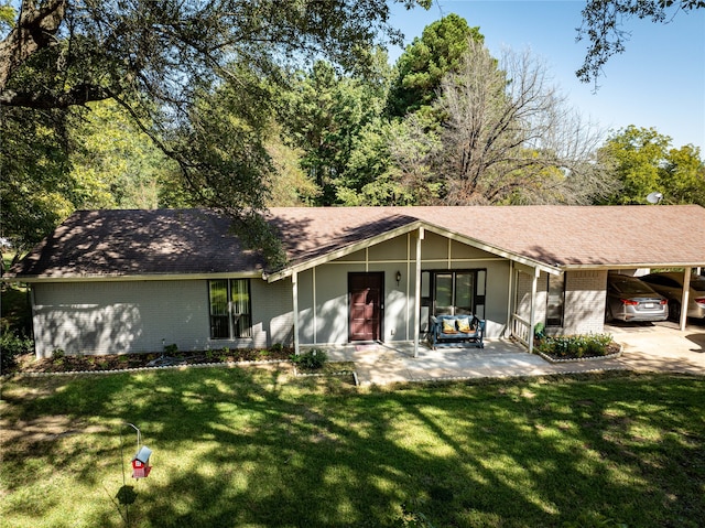 ranch-style house with a carport and a front lawn