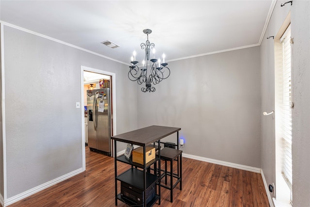 dining area with an inviting chandelier, ornamental molding, and dark hardwood / wood-style flooring