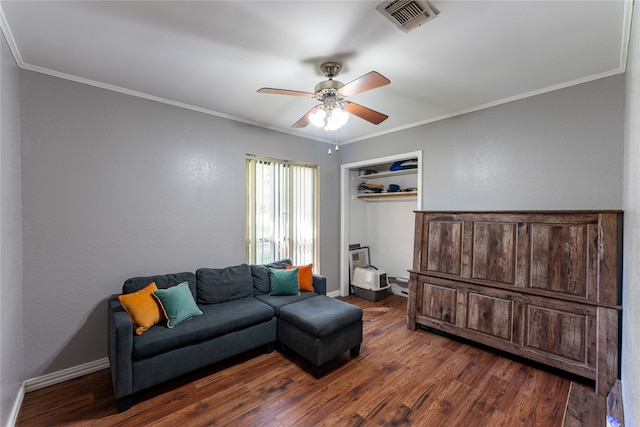 living room with ceiling fan, dark hardwood / wood-style floors, and ornamental molding