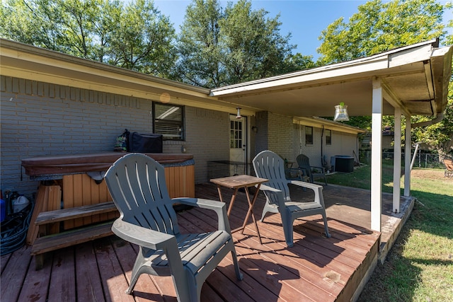 wooden terrace with cooling unit and a hot tub