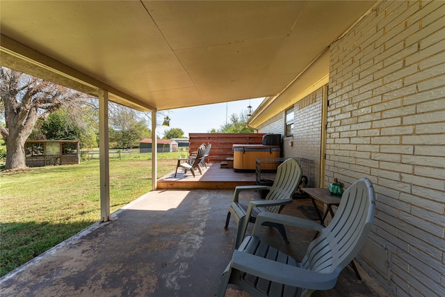 view of patio featuring a wooden deck and a hot tub