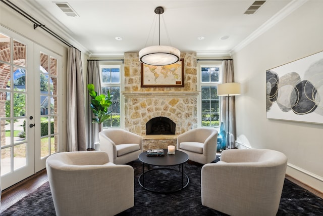 living room with french doors, a fireplace, crown molding, and dark hardwood / wood-style floors