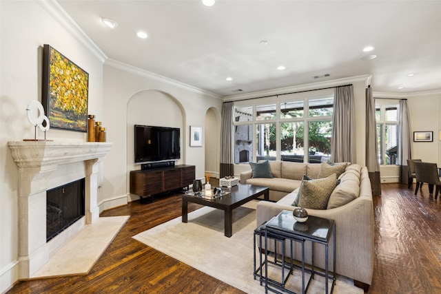 living room with ornamental molding, a premium fireplace, and dark hardwood / wood-style flooring