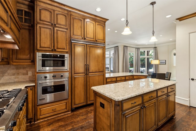 kitchen featuring stainless steel appliances, tasteful backsplash, dark wood-type flooring, pendant lighting, and ornamental molding